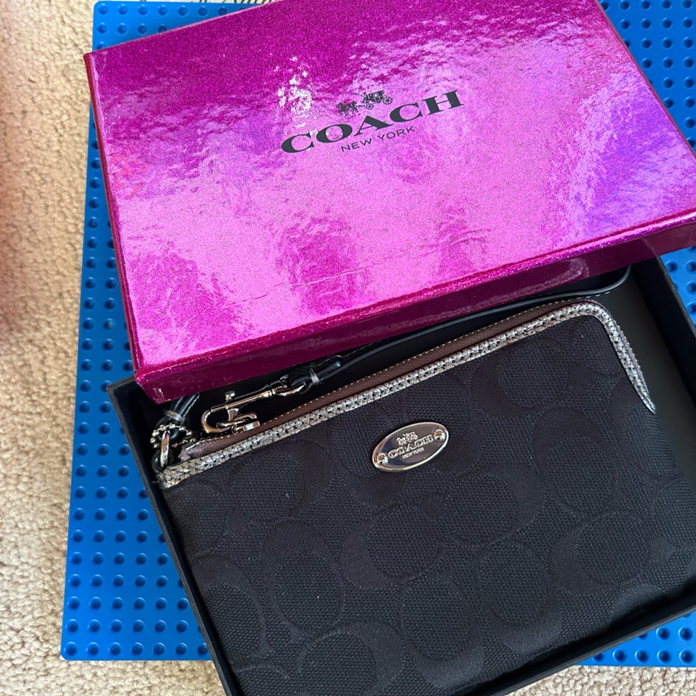 Coach wristlet, new with tags, attached in the box.